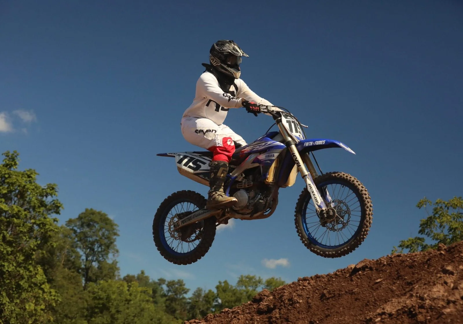 Motocross rider airborne above the track